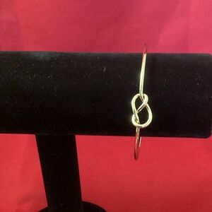 Gold tone nodded metallic cuff bracelet